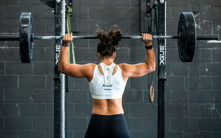 Woman lifting a barbell in the gym